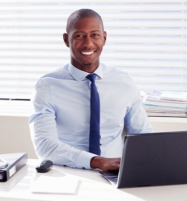 Professional man tracking cargo shipments on a laptop RGC Shipping.